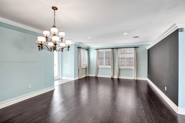 unfurnished room with a chandelier, hardwood / wood-style floors, a textured ceiling, and ornamental molding