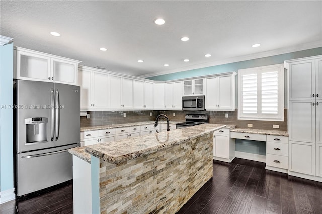 kitchen with crown molding, dark hardwood / wood-style floors, light stone countertops, appliances with stainless steel finishes, and white cabinetry