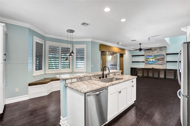 kitchen featuring stainless steel appliances, dark wood-type flooring, white cabinets, and hanging light fixtures