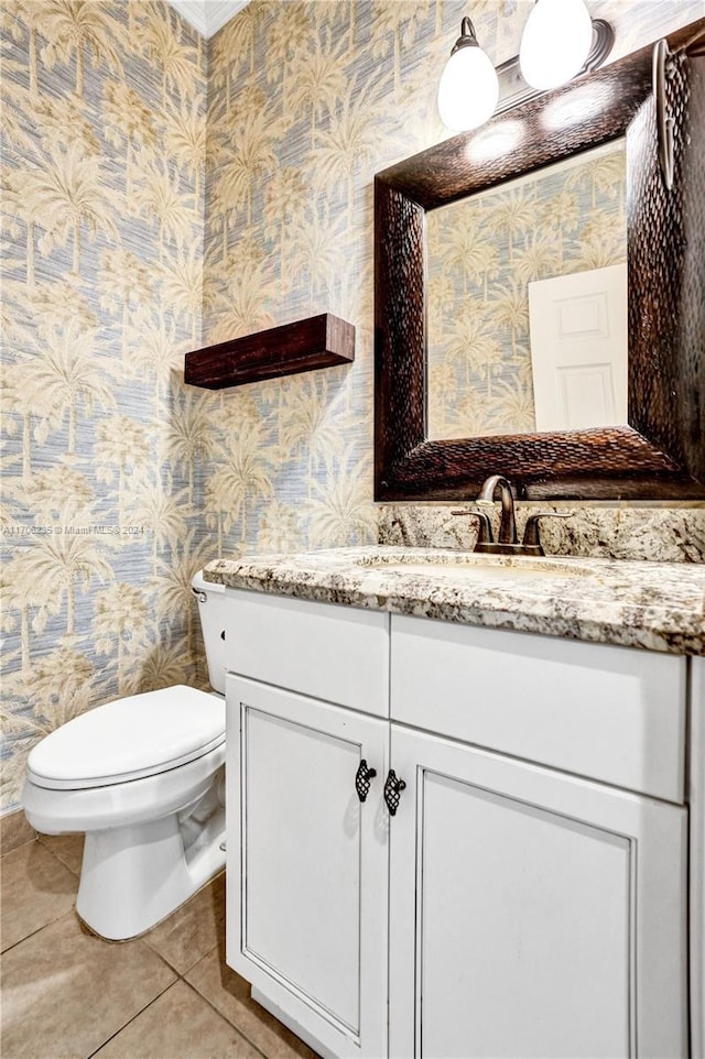 bathroom featuring tile patterned floors, vanity, and toilet