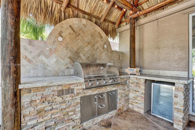 view of patio with area for grilling and exterior kitchen