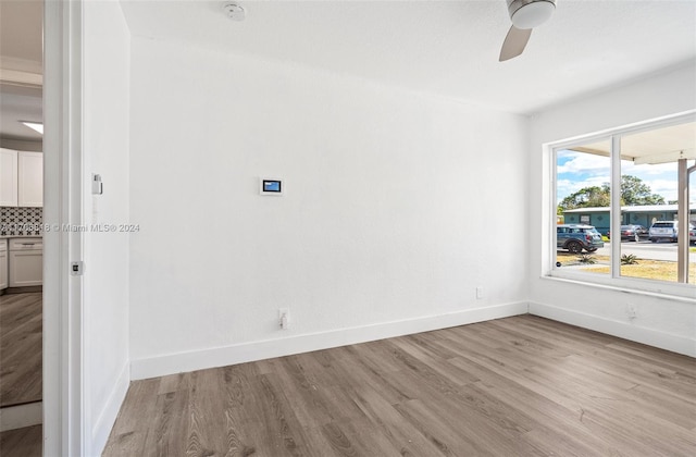 spare room featuring light hardwood / wood-style floors and ceiling fan