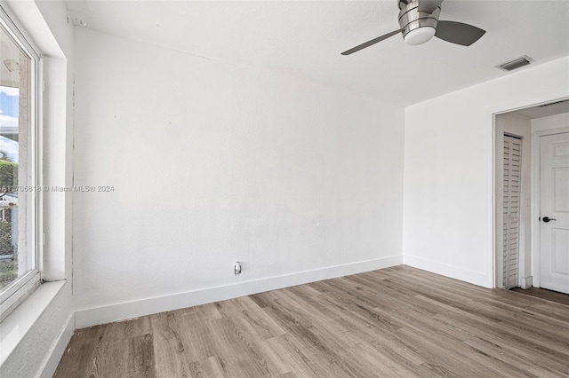 spare room with wood-type flooring and ceiling fan