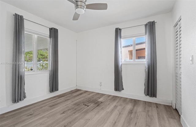 empty room featuring ceiling fan and light hardwood / wood-style flooring