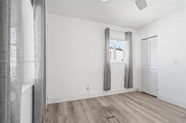 unfurnished bedroom with ceiling fan, a closet, and light hardwood / wood-style floors