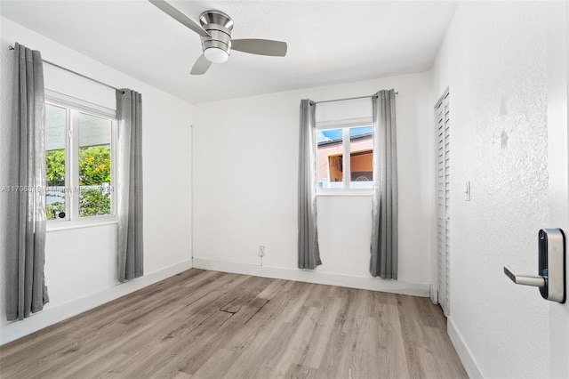 unfurnished room featuring ceiling fan and light hardwood / wood-style floors