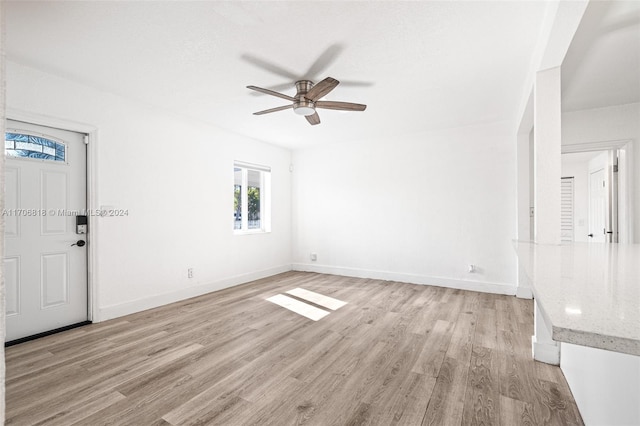 unfurnished living room featuring ceiling fan and light hardwood / wood-style floors