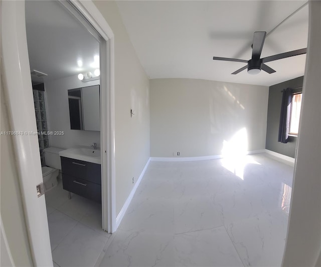 interior space with sink and ceiling fan