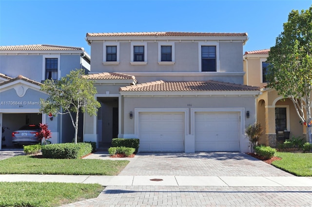 mediterranean / spanish home with a garage