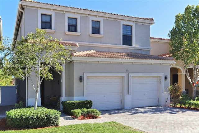 mediterranean / spanish home with a garage