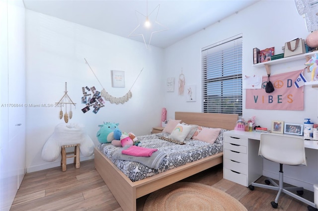 bedroom with light hardwood / wood-style floors