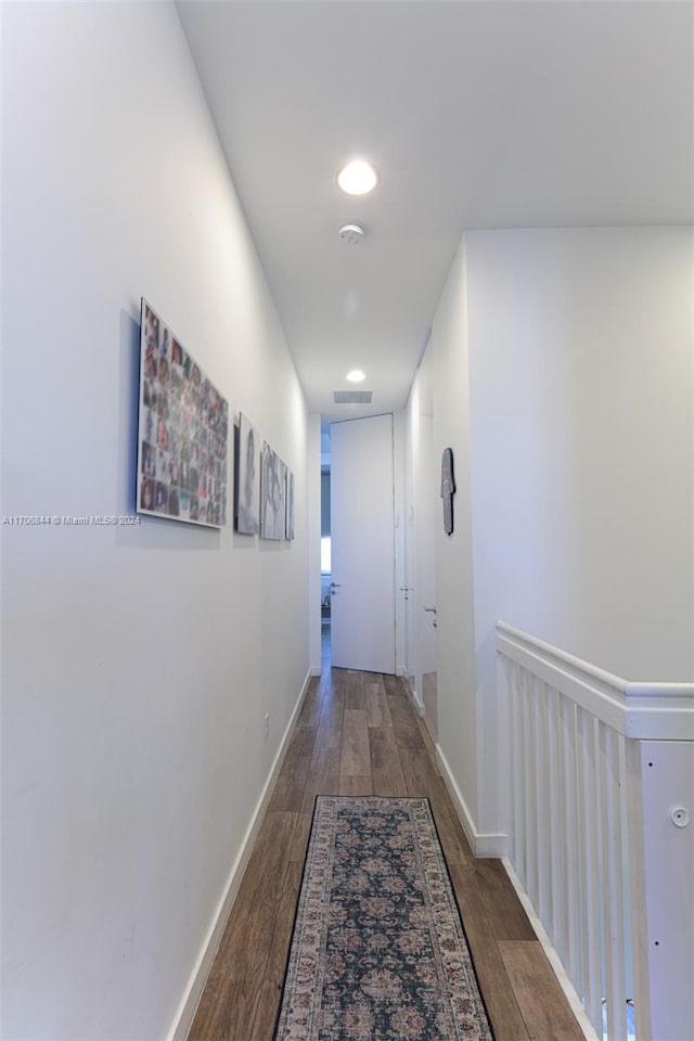 corridor with wood-type flooring