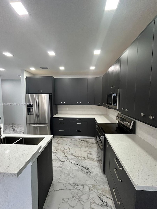 kitchen with sink and appliances with stainless steel finishes