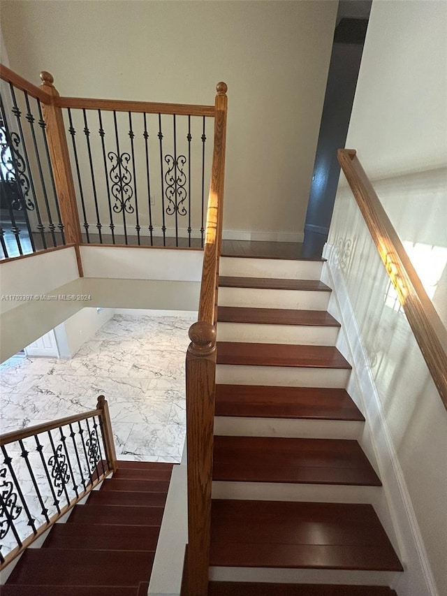 stairs featuring hardwood / wood-style flooring