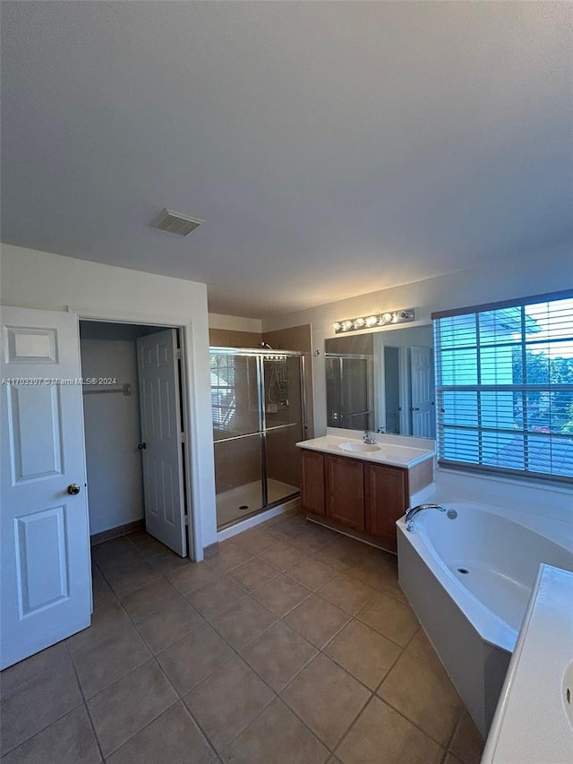 bathroom featuring tile patterned flooring, shower with separate bathtub, and vanity