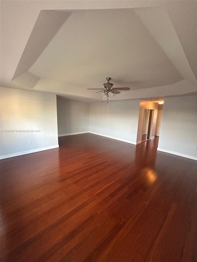 spare room with ceiling fan and dark wood-type flooring