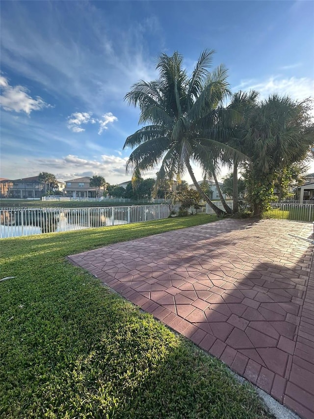 view of yard with a patio and a water view