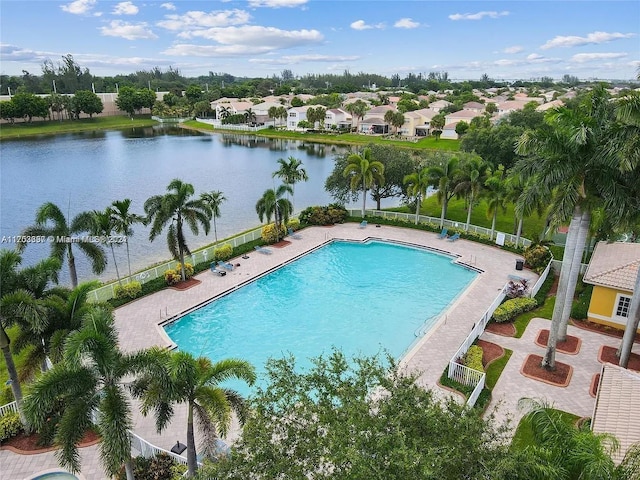 view of pool with a patio area and a water view