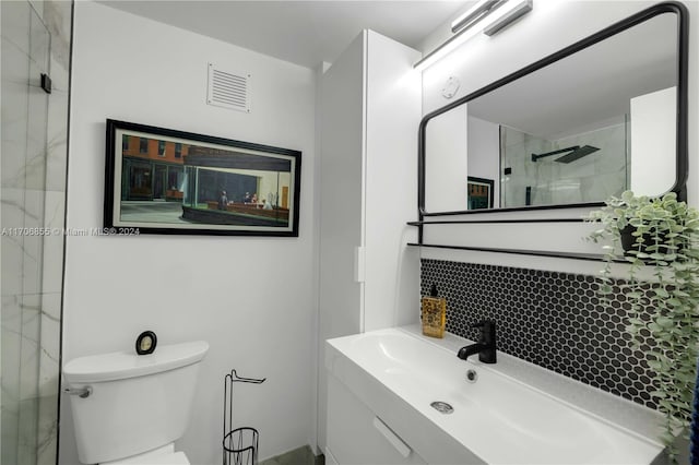 bathroom with vanity, toilet, walk in shower, and backsplash