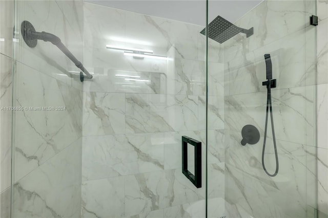 bathroom with a shower with door