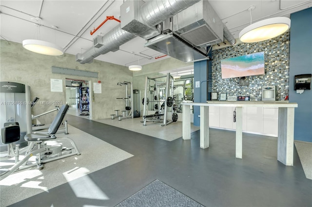 exercise room with a high ceiling