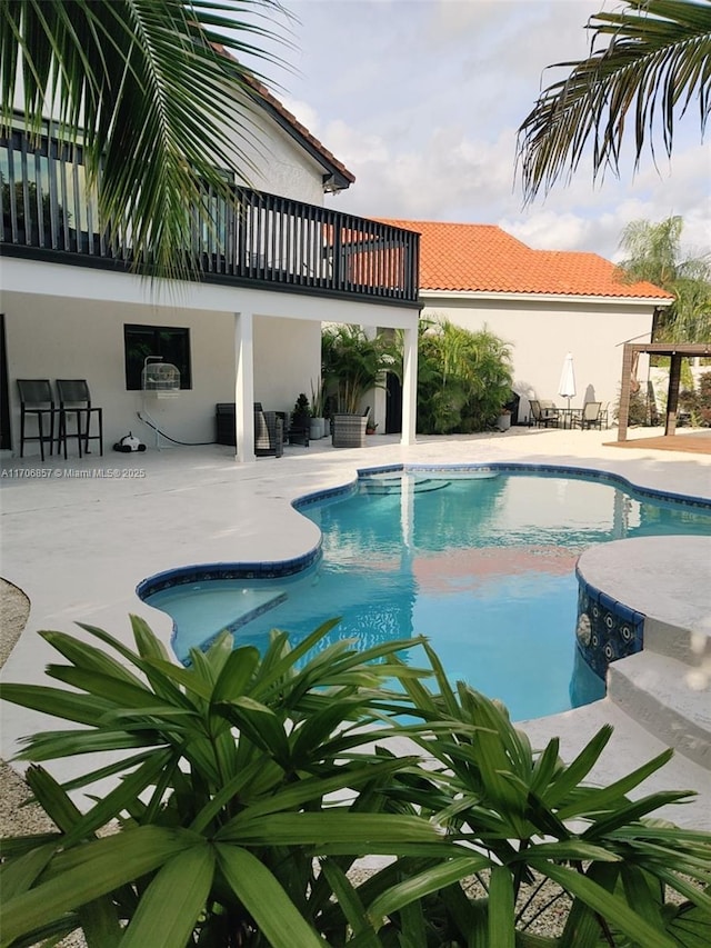 outdoor pool with a patio area