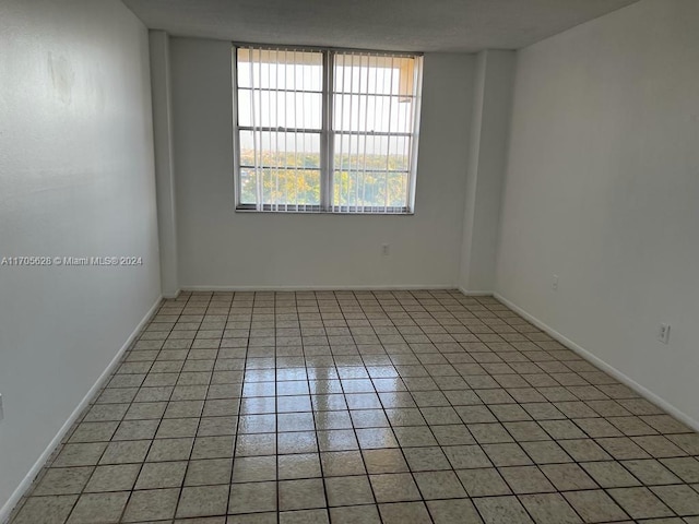 empty room featuring light tile patterned floors