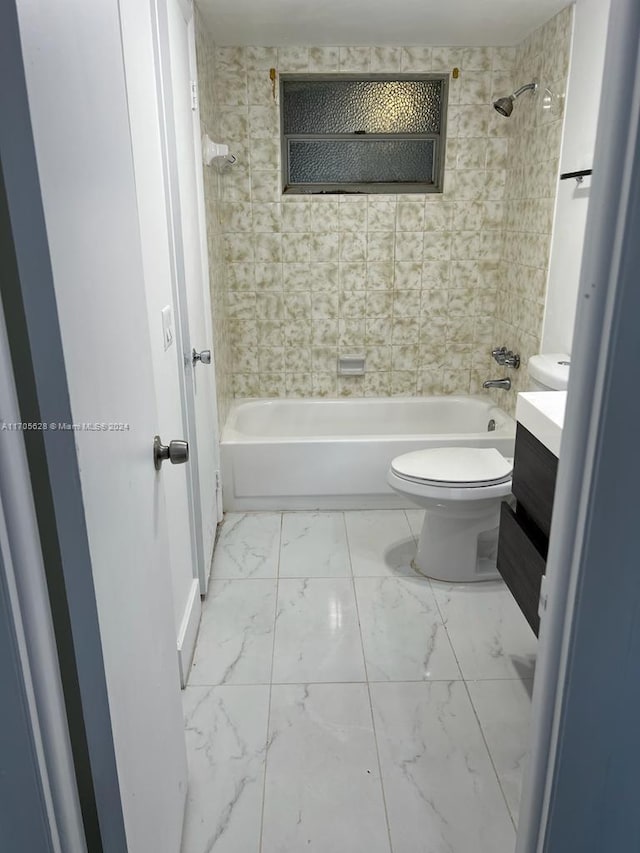 full bathroom featuring vanity, toilet, and tiled shower / bath combo