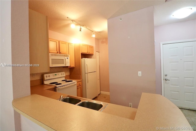 kitchen with white appliances, track lighting, sink, decorative backsplash, and a textured ceiling