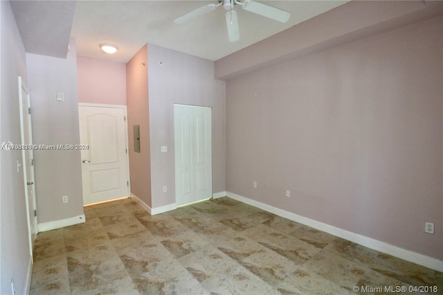 empty room featuring electric panel and ceiling fan