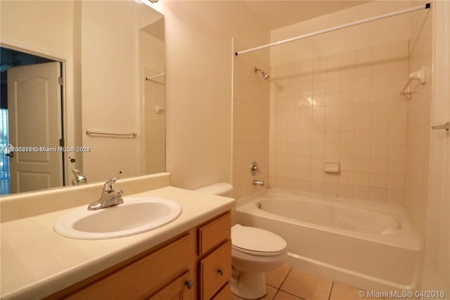 full bathroom featuring tile patterned flooring, vanity, tiled shower / bath combo, and toilet