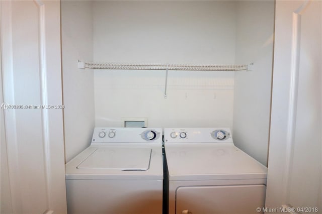 laundry room featuring washing machine and clothes dryer