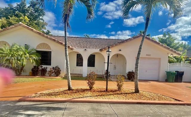 mediterranean / spanish house featuring a garage