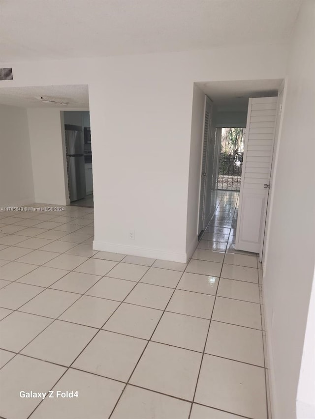 spare room with light tile patterned floors