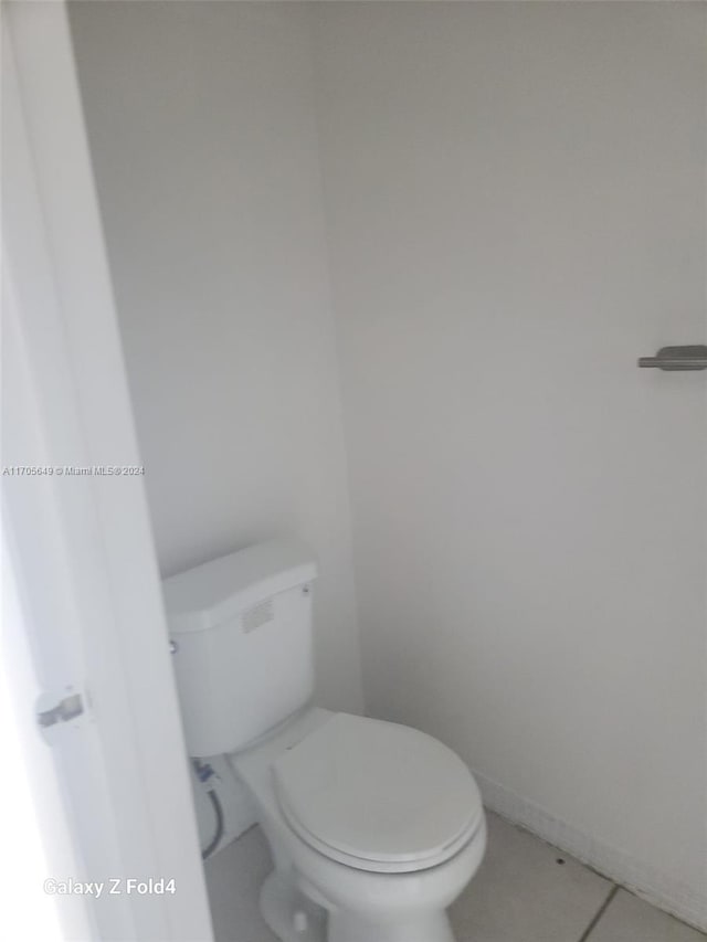 bathroom with tile patterned flooring and toilet