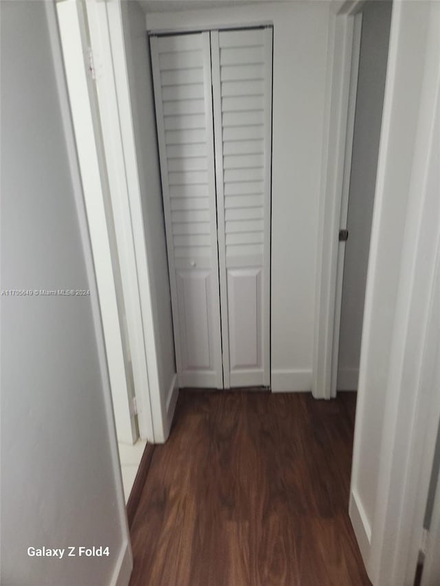 corridor with dark wood-type flooring