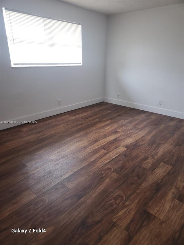 unfurnished room featuring dark hardwood / wood-style flooring