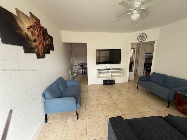 living room featuring ceiling fan and light tile patterned floors