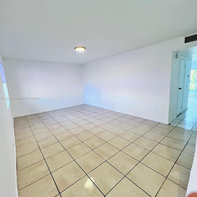 spare room featuring light tile patterned floors