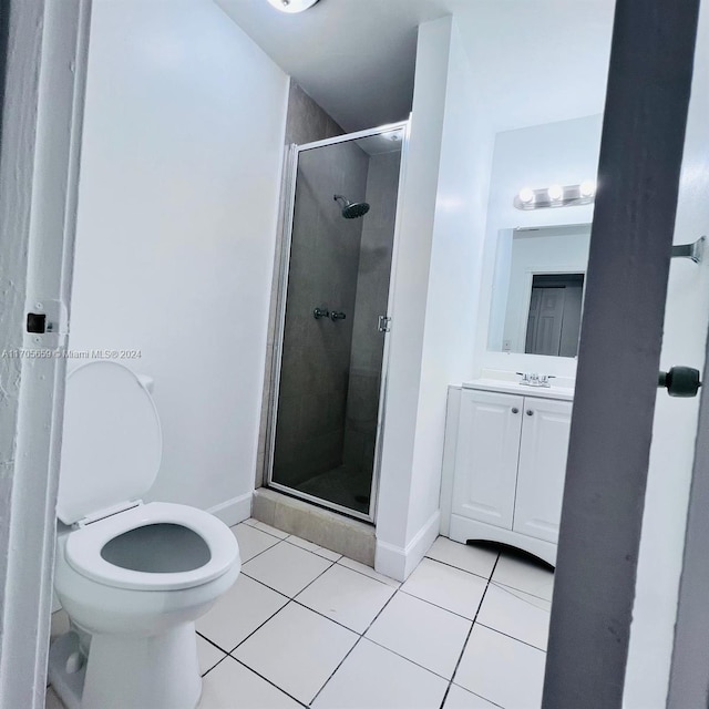 bathroom with tile patterned flooring, vanity, and an enclosed shower