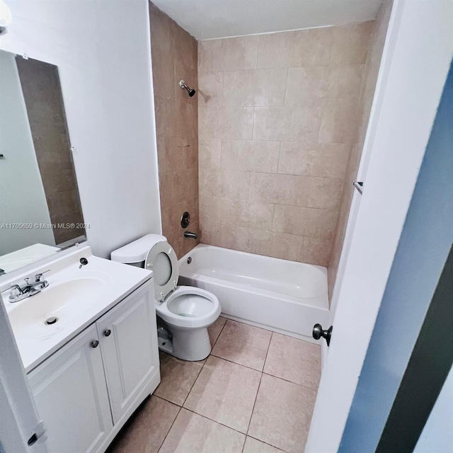 full bathroom featuring tile patterned floors, vanity, toilet, and tiled shower / bath