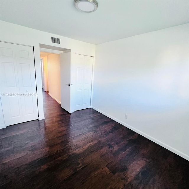 unfurnished bedroom featuring dark wood-type flooring