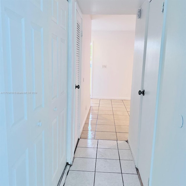 hallway featuring light tile patterned floors