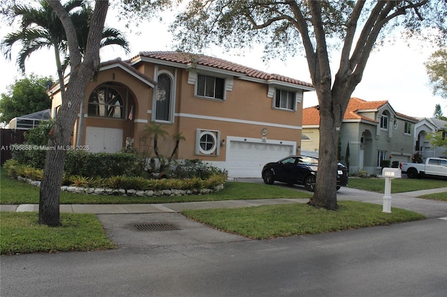 mediterranean / spanish-style home featuring a front lawn and a garage