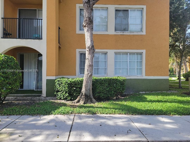 exterior space featuring a balcony and stucco siding