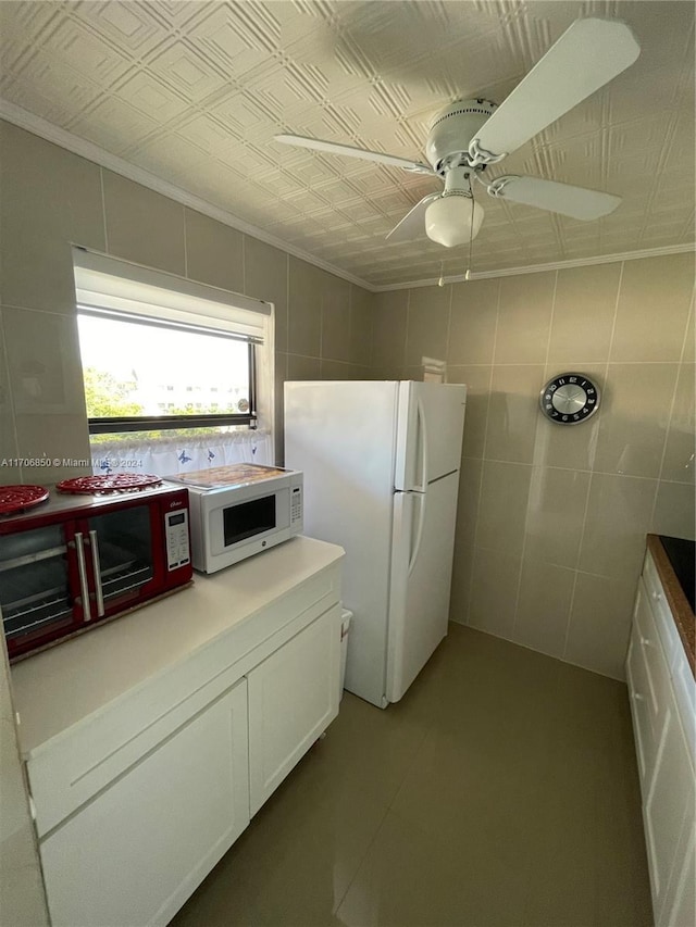 2711 NW 104th Ave Unit 406, Sunrise, FL 33322 - kitchen with white cabinets, ceiling fan, white appliances, and tile walls