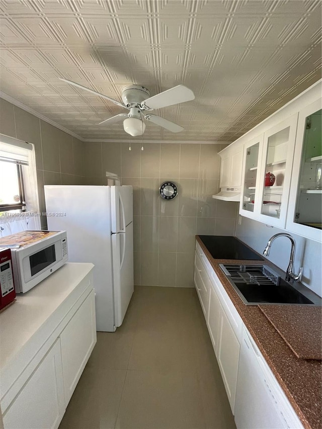2711 NW 104th Ave Unit 406, Sunrise, FL 33322 - kitchen featuring white appliances, sink, ceiling fan, tile walls, and white cabinetry