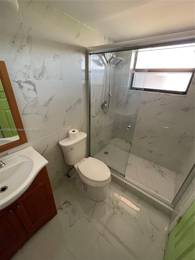 2711 NW 104th Ave Unit 406, Sunrise, FL 33322 - full bathroom featuring marble look tile flooring, a marble finish shower, toilet, vanity, and tile walls