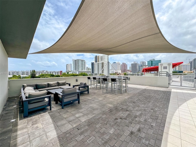 surrounding community featuring an outdoor living space, a patio area, and a bar