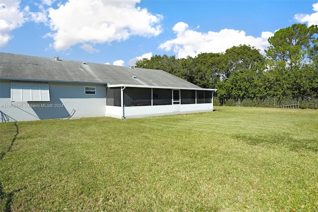 exterior space featuring a lawn and a sunroom